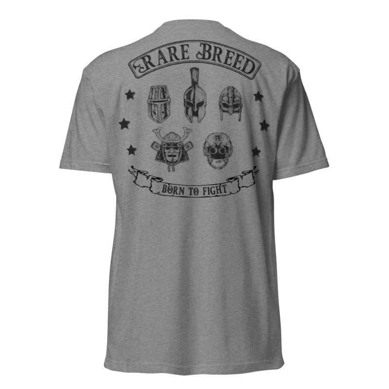 A heather gray short-sleeve t-shirt shown from the back, featuring a black graphic print with the words 'RARE BREED' and 'BORN TO FIGHT' surrounding stylized helmets and a skull.
